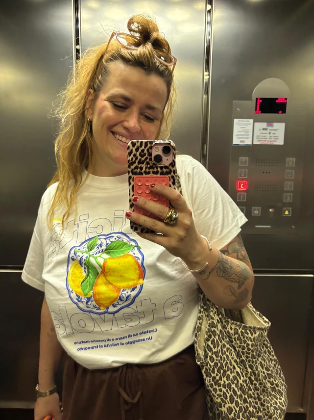 Lucie macht lachend ein klassisches Fahrstuhl-Selfie